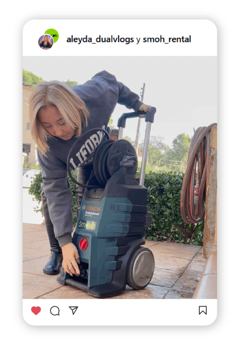 Woman crouching beside a Bosch cordless power tool on a stand outdoors, adjusting the device.