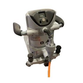 Medical treatment device with dual handles and a small digital screen, connected to an orange cable.